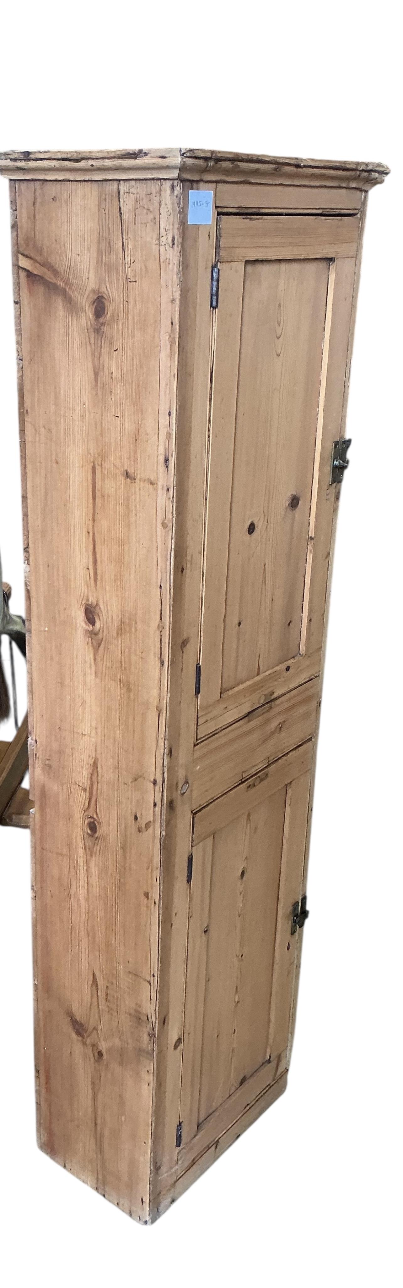 A Victorian pine narrow two door cupboard, width 43cm, depth 26cm, height 148cm